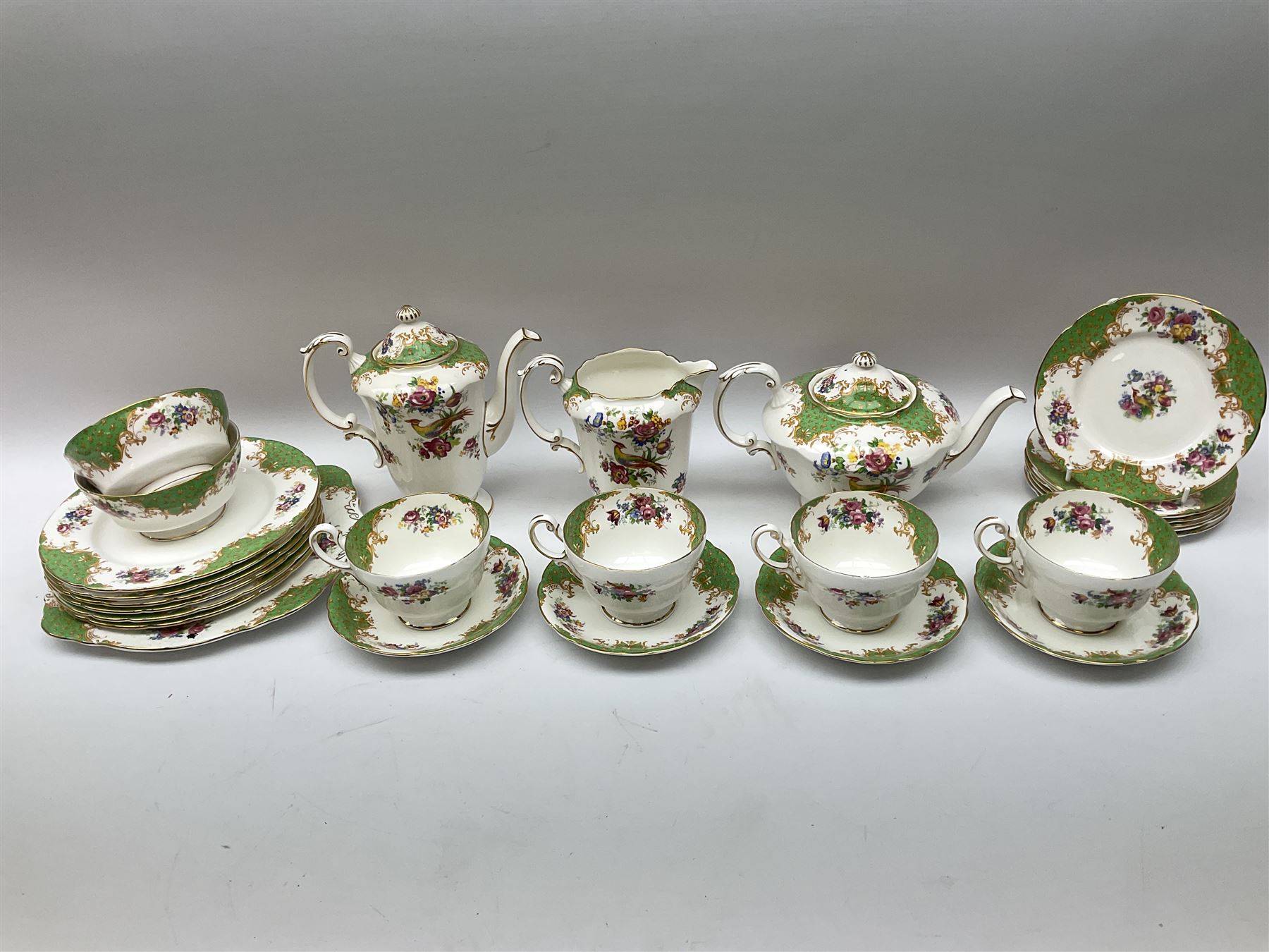 Paragon Rockingham pattern tea set, comprising teapot, coffee pot, four teacups and four saucers, six side plates, six dessert plates, cake plate, two open sucriers, and jug. 