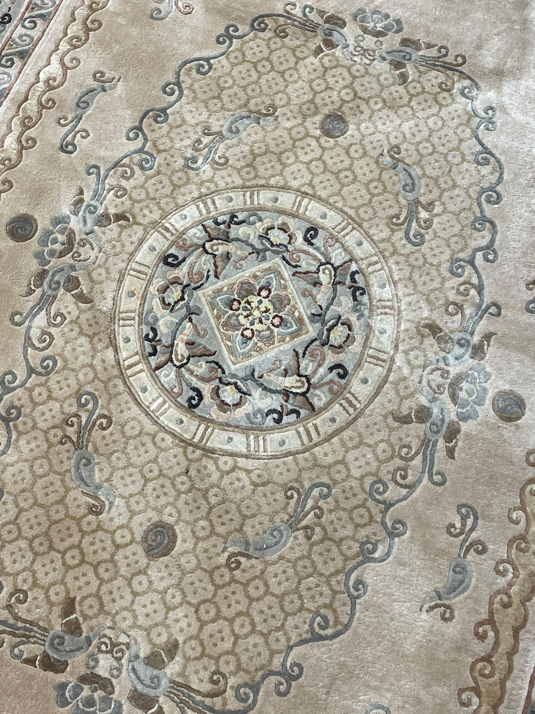 Chinese washed woollen camel ground rug, circular medallion surrounded by scrolls, the border decorated with birds and trailing floral decoration (248cm x 155cm); Chinese washed woollen pale green ground rug (125cm x 69cm); Persian design rug (186cm x 121cm) (3)