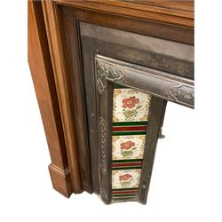 Early to mid-20th century mahogany fire surround, stepped arched top with oval bevelled mirror, fitted with shelf with fluted frieze, together with an early to mid-20th century metal fire inset with tiled uprights