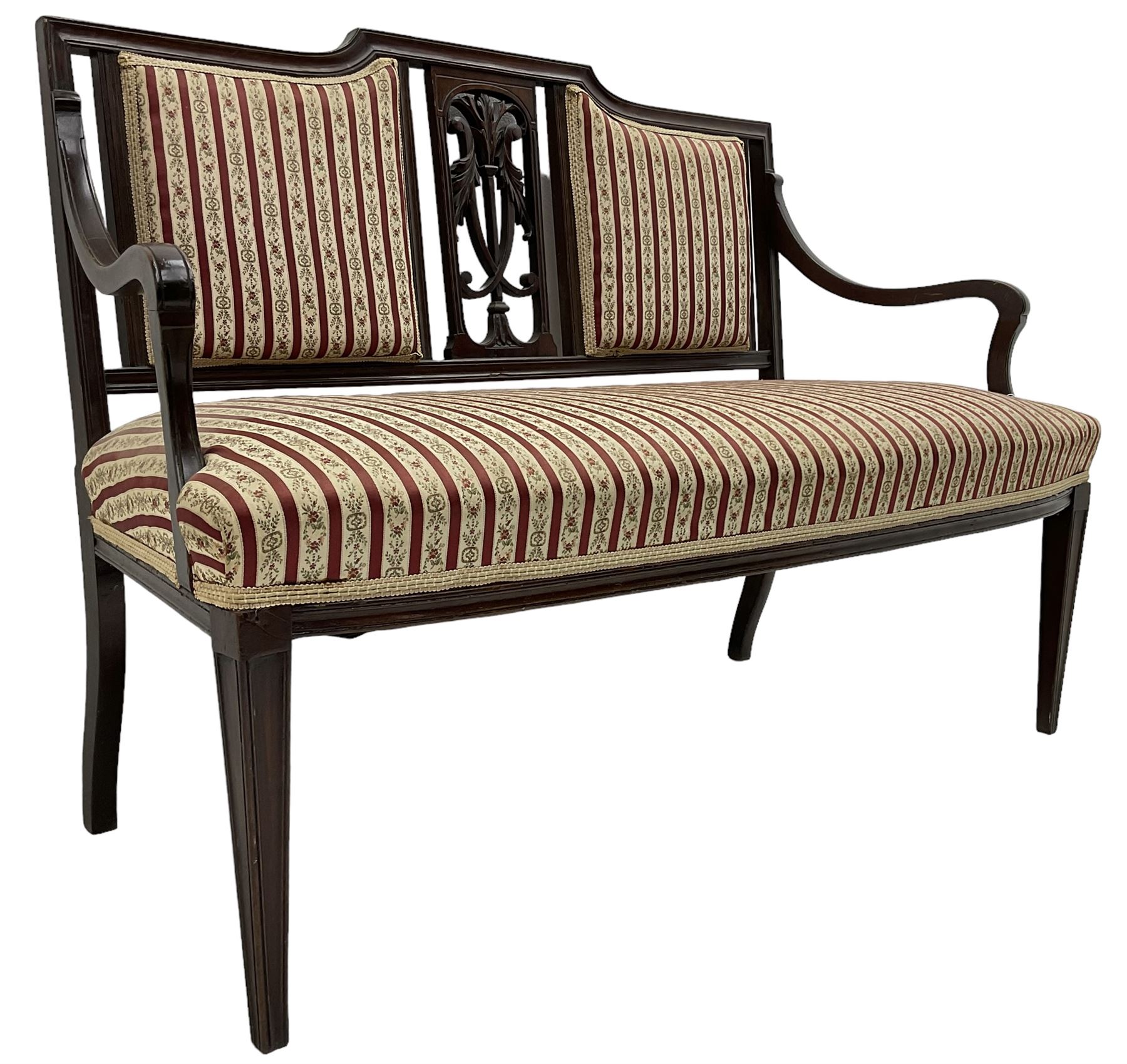 Edwardian mahogany framed three-piece salon suite - two-seat sofa, stepped cresting rail over acanthus and scroll carved pierced splat, upholstered in striped fabric (W124cm, H87cm, D62cm); and a pair of matching armchairs (W60cm) 
