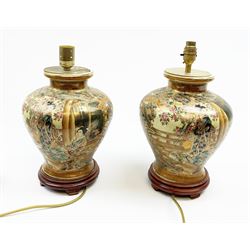 A pair of 20th century Japanese Satsuma style table lamps, decorated with figural scenes and heightened with gilt, each upon wooden base, overall H39cm. 