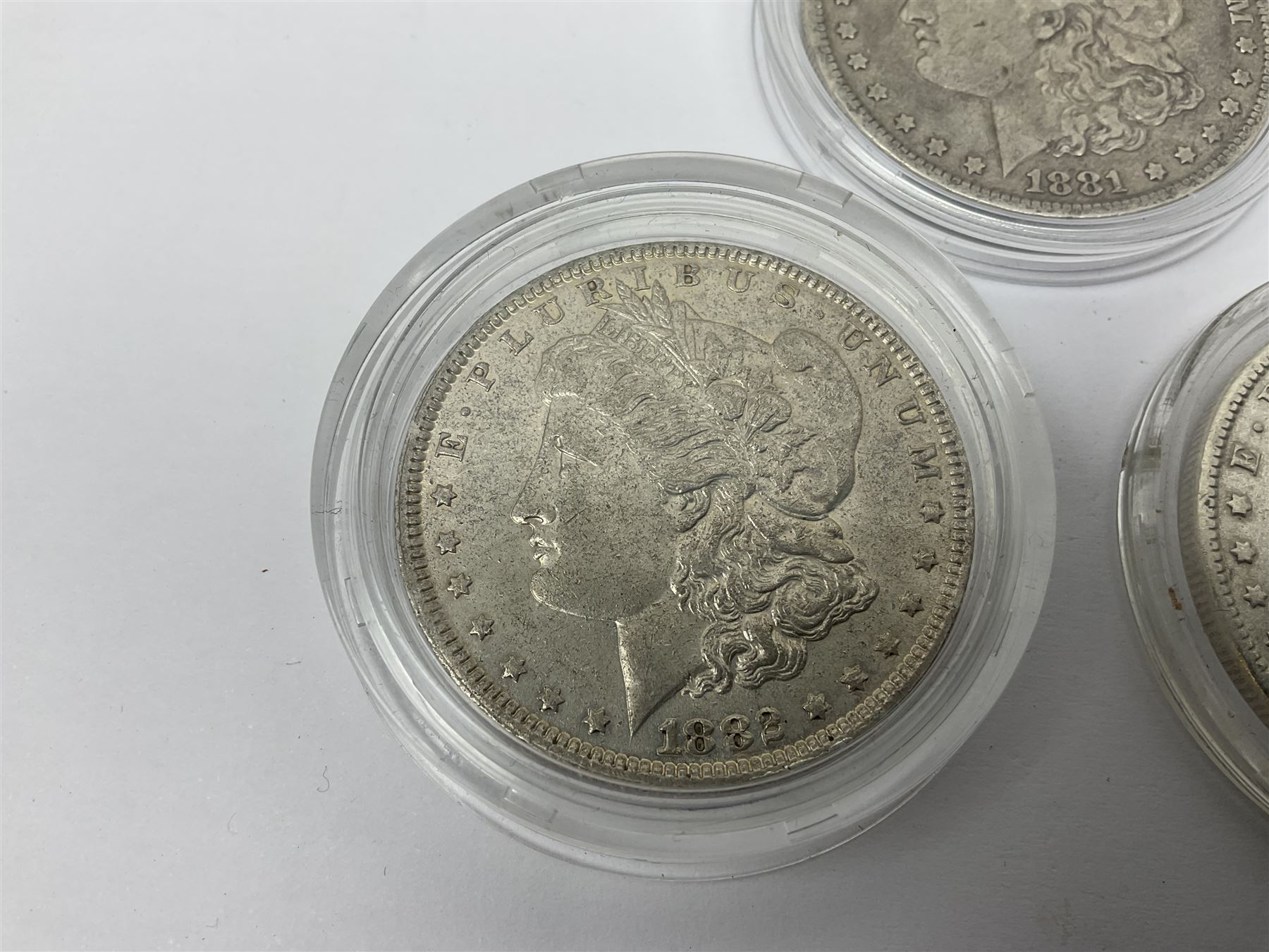 Three United States of America silver Morgan dollar coins dated 1881 O, 1882 and 1882 O