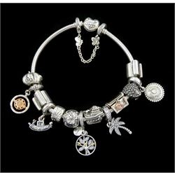 Pandora Moments heart clasp silver bracelet with thirteen silver Pandora charms and a silver Pandora safety chain