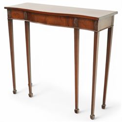 Edwardian mahogany serpentine side table or console table, figured frieze decorated with applied carvings, on six square tapering supports with spade feet