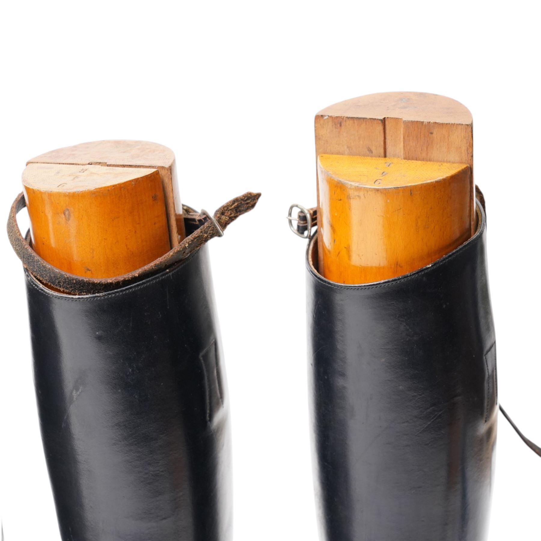 Two pairs of leather riding boots with wooden trees