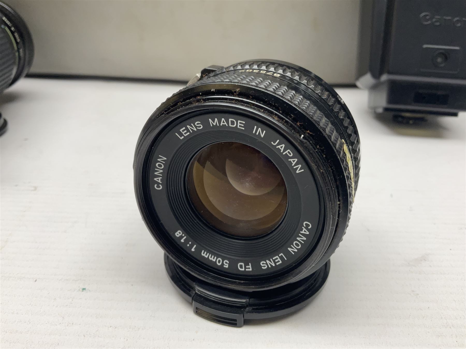 Canon A1 35mm camera body serial no 741264, with 'Tokina AT-X 28-85mm 1:3.5-4.5' lens serial no 821679, 'Canon FD 50mm 1:1.8mm' lens and other camera equipment 