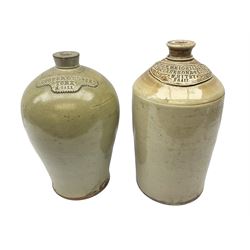 Two large 19th century stoneware bottles or flagons, the first example of baluster form detailed 'Cooper & Close York 2 Gall', the second of cylindrical form detailed 'John Weighill & Sons Late Clarkson & Weighill Whitby 2 Gall', each approximately H40cm