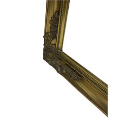 Large rectangular wall mirror, swept gilt frame decorated with floral cartouches, bevelled plate