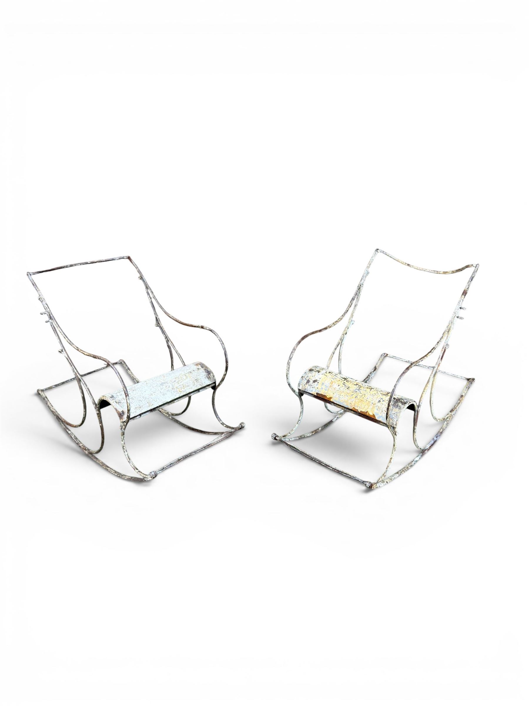 Pair of white painted cast metal garden chairs, ornate reclined backs, circular pierced seats on cabriole legs