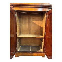 19th century mahogany break-fronted quadruple wardrobe, stepped and moulded projecting cornice over four arch panelled doors, moulded plinth base on blocks 