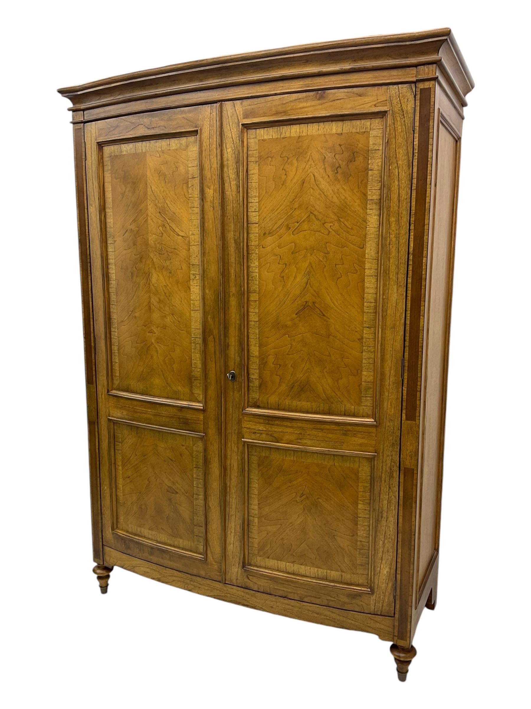 Frank Hudson - mid-20th century Mindi ash and burr walnut double wardrobe, moulded rectangular cornice over two panelled doors with chevron pattern veneers, raised on turned supports
