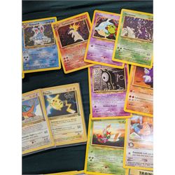 Collection of Pokemon TGC trading cards, including two WB First Movie Black Star promo cards Pikachu no. 4 and Dragonite no. 5, two Ancient Mew Black Star holo promo cards, Gym Challenge Giovanni's Persian 8/132 holo and a small collection WOTC, Neo Discovery and Neo Genesis cards, together with thirty four Bandai Carddass Pokemon cards, including prism Charizard no. 186 and Pokemon Topps cards including holo examples 