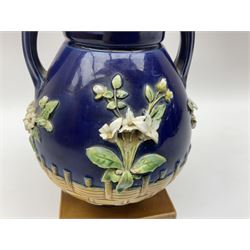Minton majolica vase, the squat body with twin handles, with part osier moulding and applied Spring flowers against a cobalt blue ground, upon integral square base, impressed beneath Minton 1316, H16.5cm