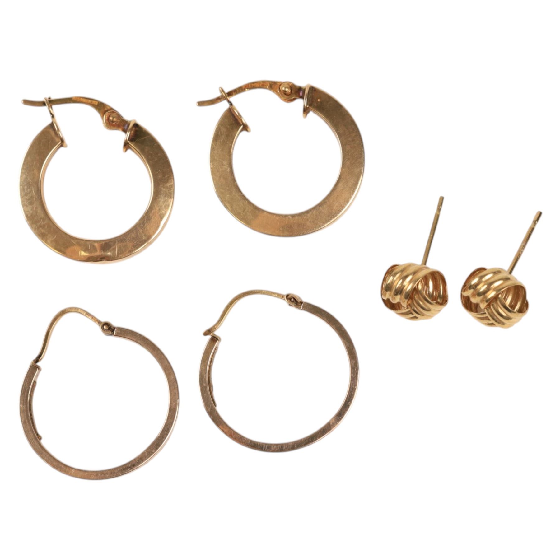 Two pairs of 9ct gold hoop earrings and a pair of 9ct gold knot earrings