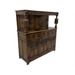 20th century carved oak court cupboard, s-scroll carved frieze over panelled cupboard door carved with arch, lobe and scroll carved cup and cover supports, fitted with three drawers and three cupboards below