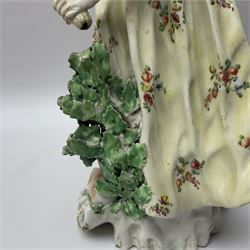 18th century Derby figure of Diana the huntress, circa 1760, modelled reaching for an arrow from quiver across her back, with recumbent hound at her feet, upon a scrolled base with bocage detail, H27.5cm