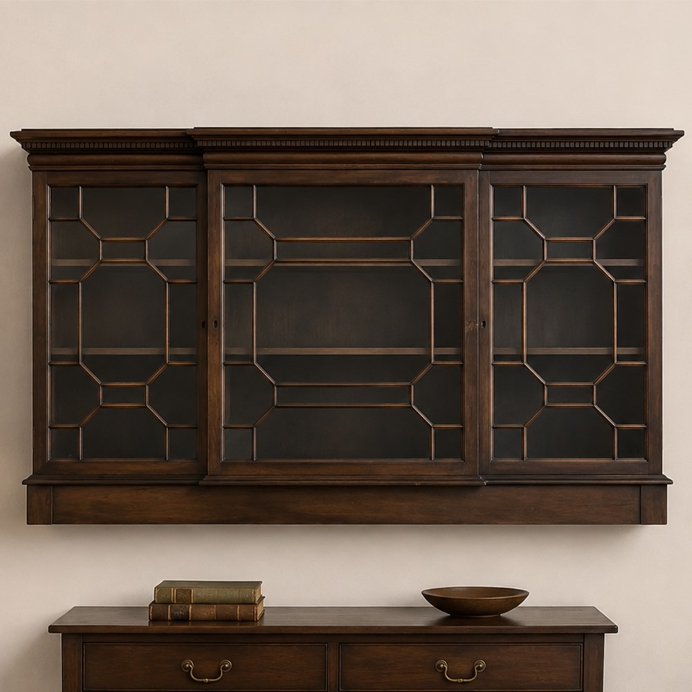 Early 20th century mahogany breakfront wall hanging bookcase, projecting dentil cornice over astragal glazed doors