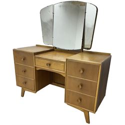 Meredew - mid-20th century oak kneehole dressing table, raised triple mirror back over seven drawers 