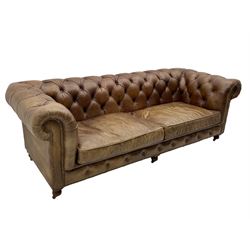 HALO - Chesterfield style four seat sofa upholstered in buttoned brown leather with stud work, on turned feet with castors