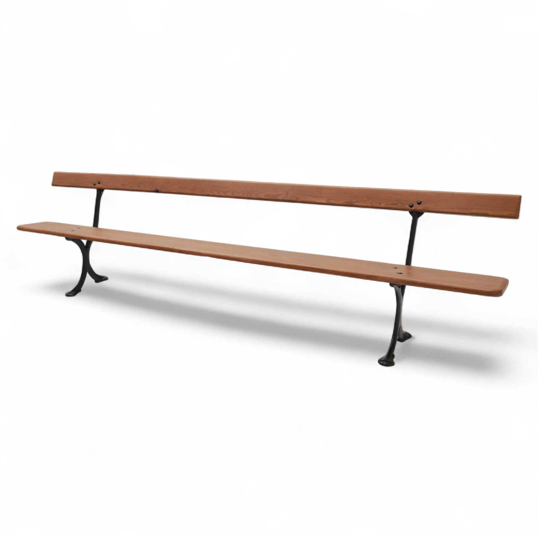 Pine garden bench, with stained and weatherproof varnish, single slat pine seat and back, raised on curved black cast iron supports