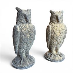 Pair of large composite stone garden statues modelled as standing horned owls, raised on circular bases