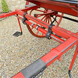 Holland & Holland Tandem Cart - Althorp Spencer Family Estate

A two wheeled tandem cart or cocking cart by Holland & Holland Coach Builders, London, with black painted bodywork, red painted shafts and running gear, red wooden spoked wheels with rubber tyres, green upholstered seating and a rear perforated metal footboard. The cart is fitted with carriage lamp brackets (lamps next lot), green buttoned cushions with leather retaining straps, side louvered body panels, footrests, leaf spring suspension and shafts for horse use. The carriage incorporates an adjustable body position, operated by a lever, allowing the body to be moved forwards or backwards to alter the weight distribution. Formerly owned by the family of Lady Diana Spencer,
Sympathetically conserved by Woods of Fairbourne Carriages Ltd, Kent.

Features:
• Brass maker’s plaque for Holland & Holland Coach Builders, London
• Two wheeled tandem cart
• Black painted body with red painted shafts and running gear
• Red wooden spoked wheels with rubber tyres
• Green upholstered cushions with leather retaining straps
• Adjustable carriage body for weight distribution
• Lever operated adjustment mechanism
• Perforated rear footboard
• Side footrests
• Louvered side panels
• Leaf spring suspension
• Rear opening storage compartment
• Decorative painted armorial motif to rear panel
• Fitted carriage lamps shown, not included in the lot (available as next lot)
• Conserved by Fairbourne Carriages Ltd
• Provenance: The Althorp Attic Sale including The Spencer Carriages, lot 195, 7 July 2010

Dimensions:
Overall length 396 / 198cm
Width 155cm
Height 190cm

Wheel Diameters:
Wheels: 148cm

Seating:
Driving seats: 2
Passenger seats: 2