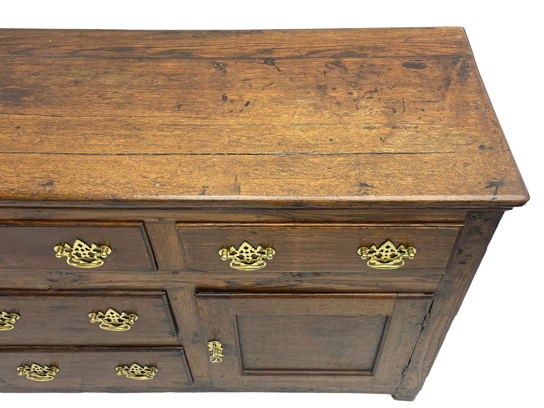 George III country oak dresser base,  rectangular top over with three central drawers flanked by two drawers and two panelled cupboards, each with moulded fronts, on stile feet