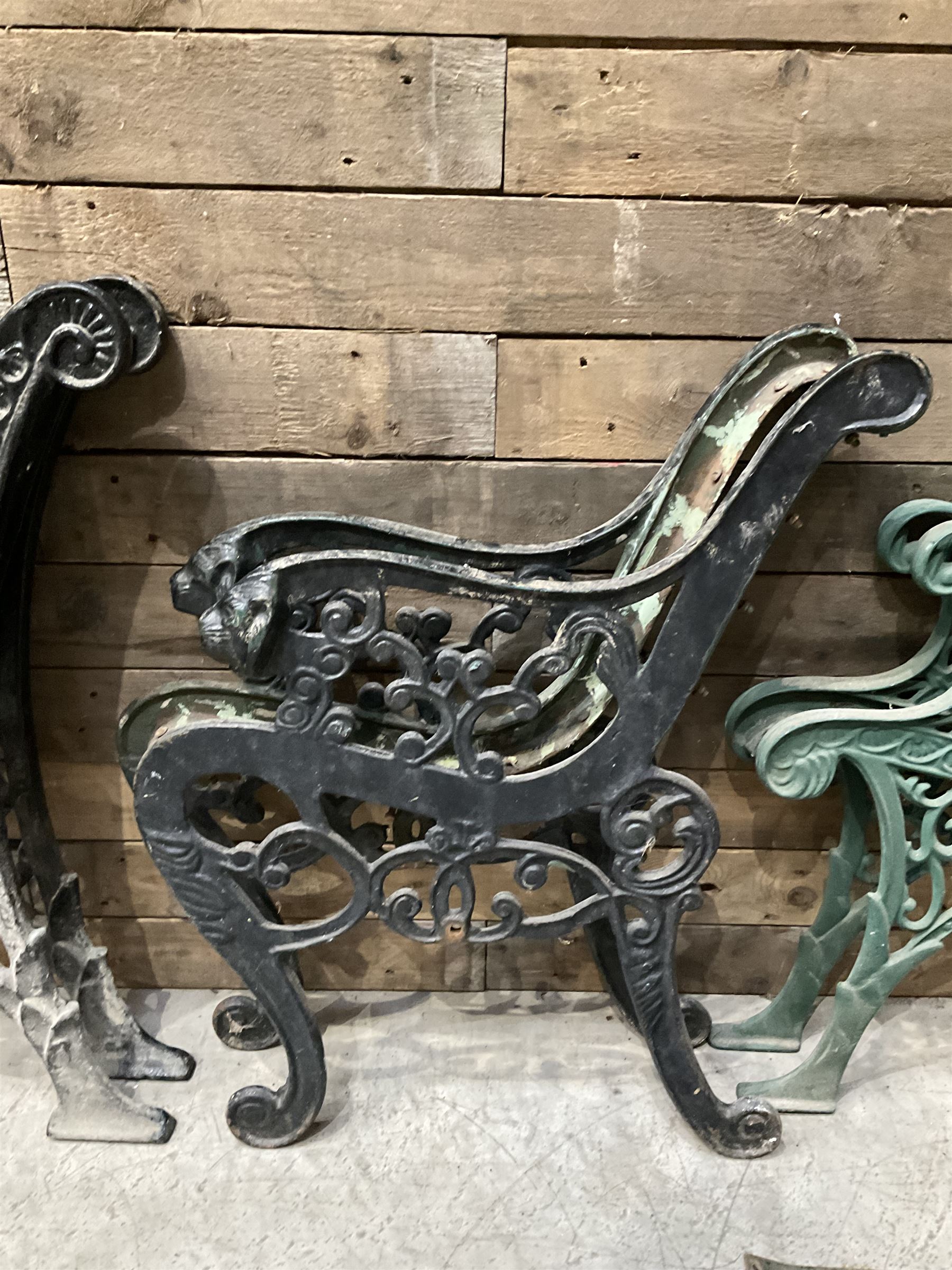 Four pairs of ornate cast iron bench ends (8)