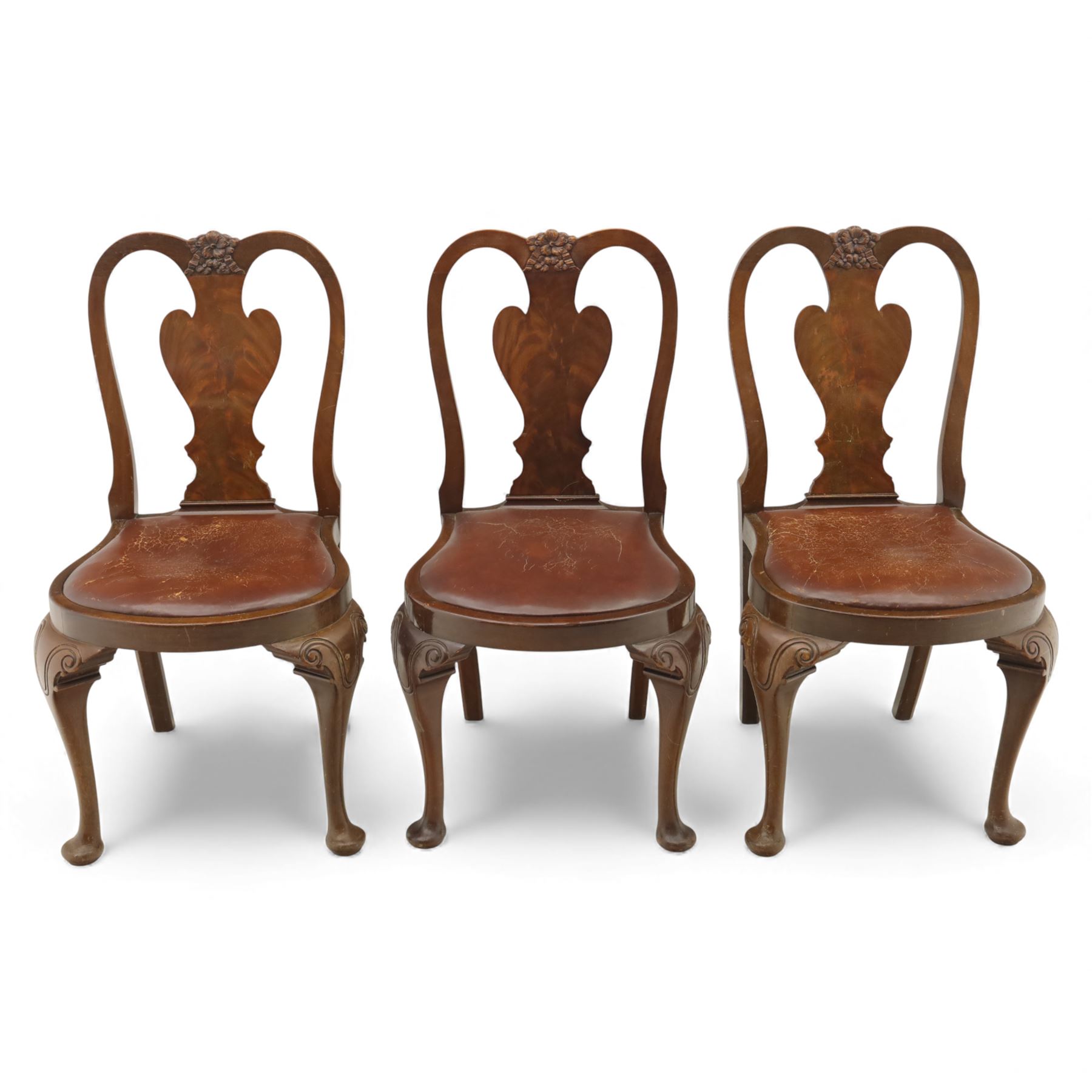 Queen Anne design walnut dining suite, comprising a rectangular dining table with carved moulded edge and rounded corners, raised on cabriole legs terminating in pad feet, together with a set of six matching dining chairs, each with shaped splat back, leather upholstered seat and cabriole supports (Extends to 230cm)