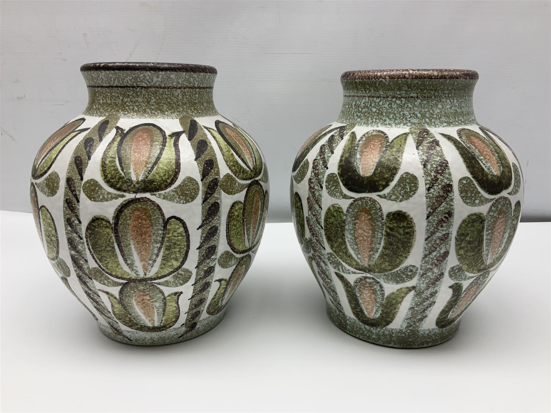 Pair of Denby Glyn Colledge stoneware vases of baluster form with floral decoration over cream ground, together two jardiniere in a similar design, vases H24cm