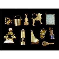 Ten 9ct gold charms including piano, violin, boat, crab, poodle, and lantern, hallmarked or stamped and a gilt bloodstone seal fob