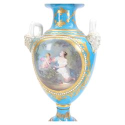 Pair of late 19th century Sevres style vases, each of urn shaped form with twin mask mounted raised handles, decorated with romantic figural and landscape panels within 'jewelled' and gilt foliate borders, with pseudo Sevres marks beneath, H35.5cm