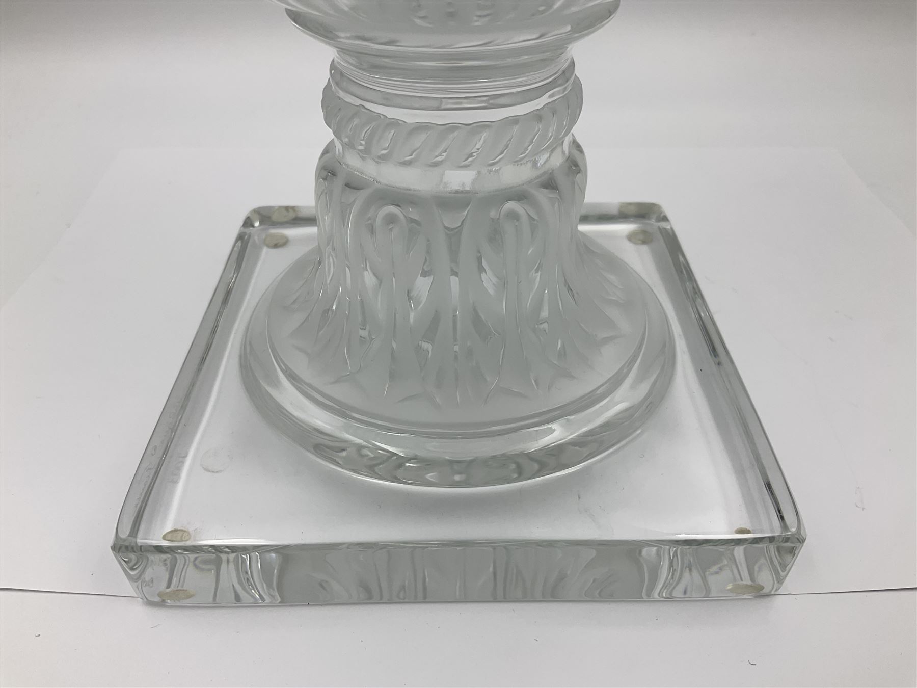 Large and impressive Lalique Versailles pattern glass vase, of classical baluster form with gadrooned flared rim, the body moulded in relief with fruiting vines above part fluting, upon a spreading circular foot with moulded decoration, and plain square plinth base, signed Lalique France to side of plinth, overall H35cm, with original box 