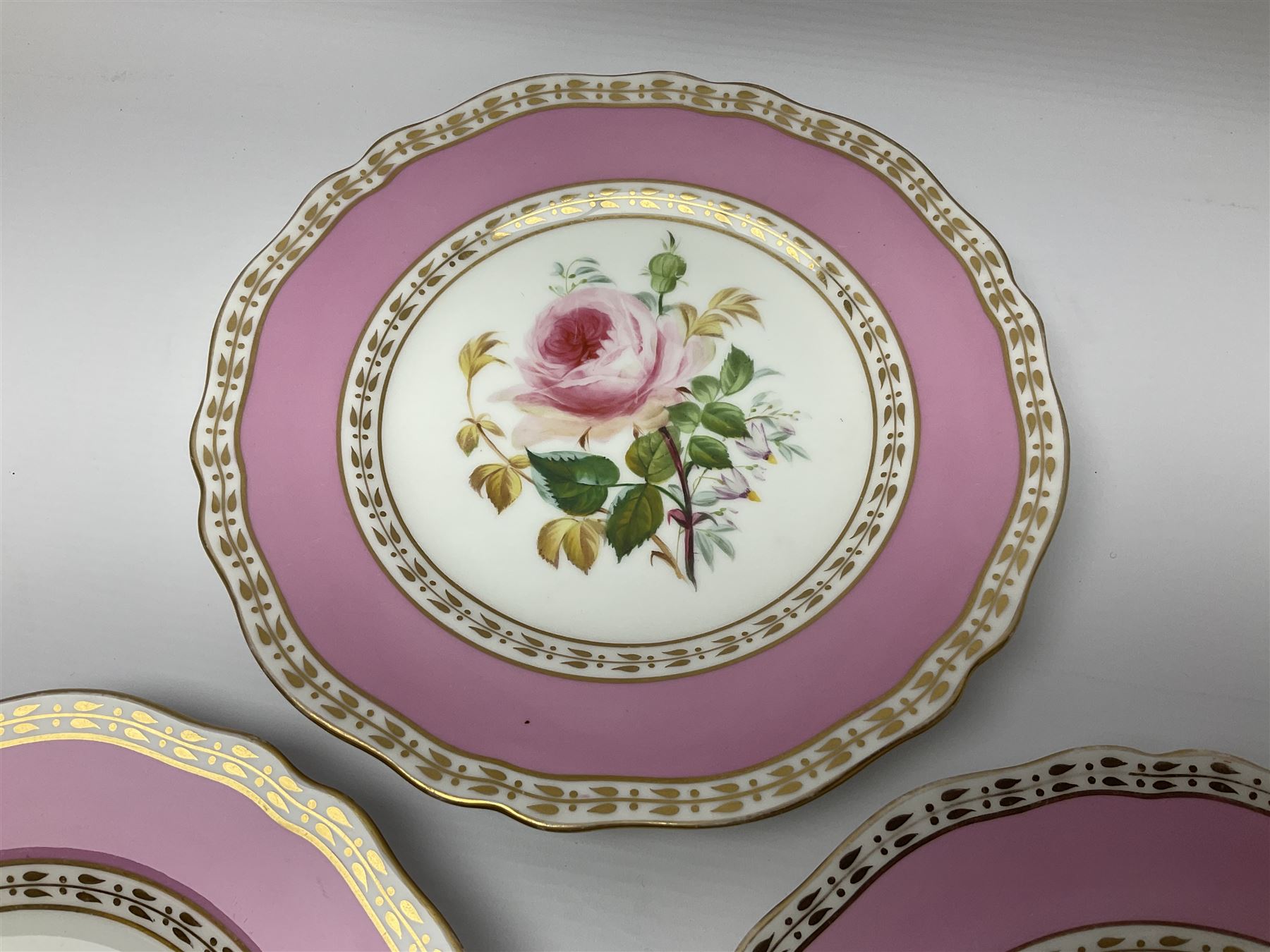 Victorian Copeland, Botanical dessert service, decorated with floral sprigs to the centre with a pink and gilt border, comprising five comports and seven plates, largest comport H20cm, plate D22cm
