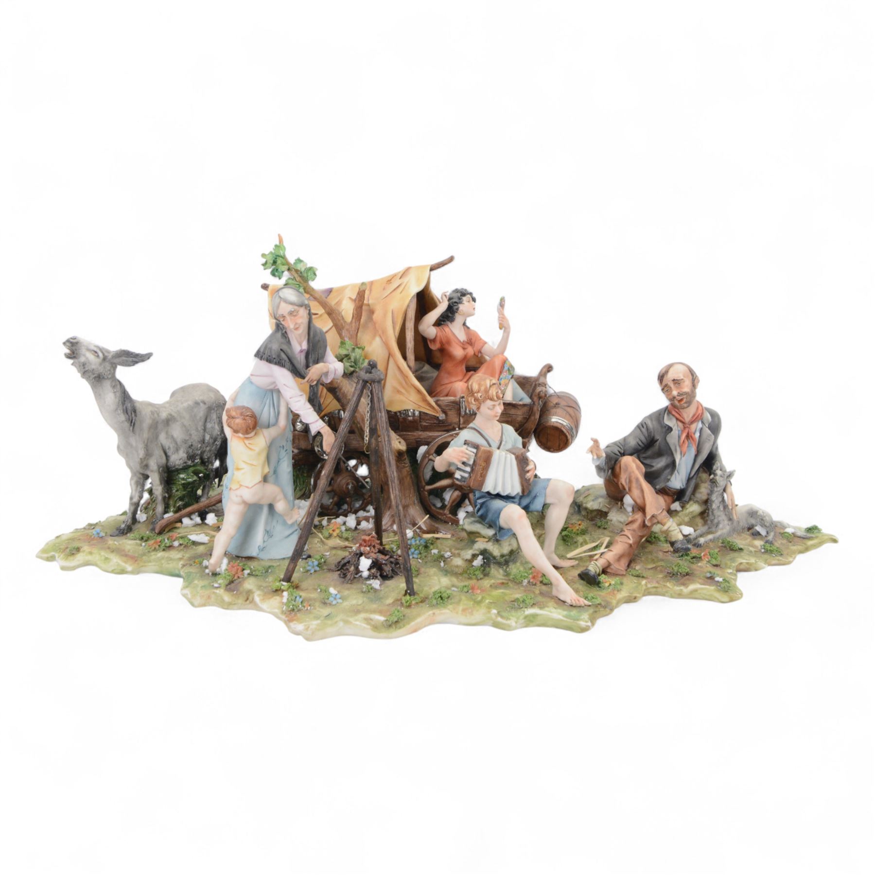 Capodimonte figural group of a gypsy encampment including wagon, cooking fire and people, H21cm