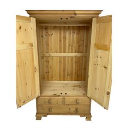 Pine double wardrobe, moulded cornice, fitted with two panelled doors over three drawers, on ogee feet