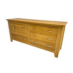 Contemporary wide oak straight-front chest, fitted with a bank of six drawers with chrome handles, on tapered feet