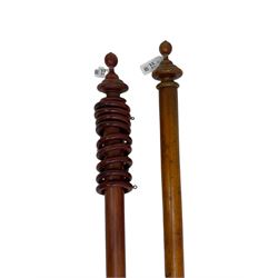 Two Victorian stained beech curtain poles, each with turned finial terminals, (L214cm & L222cm, total lengths)