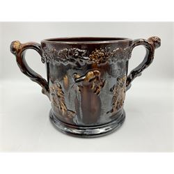 Large 19th century Staffordshire treacle glazed frog loving cup, the treacle glazed body decorated in relief with busts of Nelson, other naval figures, tavern scenes and fighting dogs, the interior with two pottery frogs in buff and treacle glazes, H17cm 