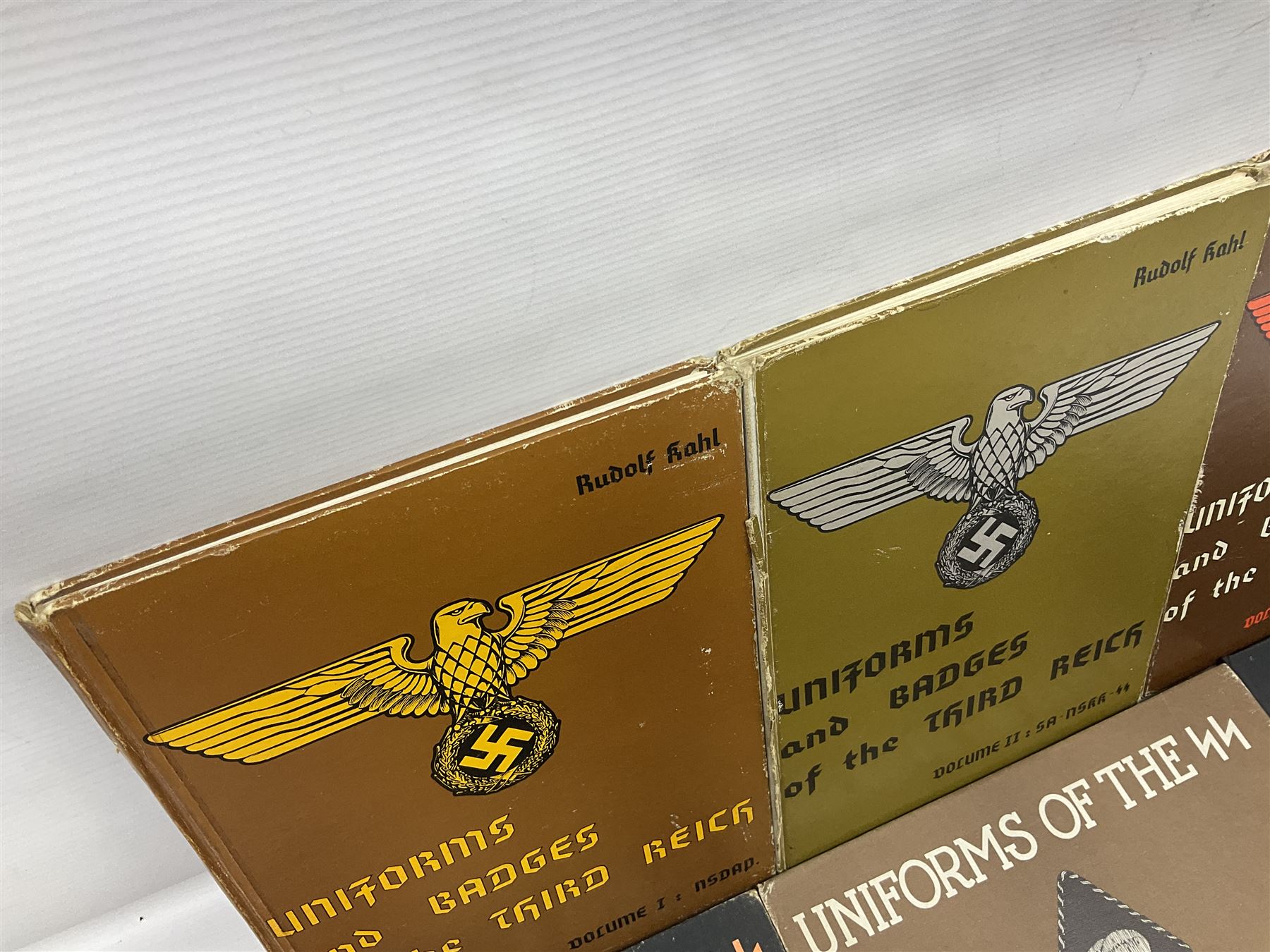 Military Collectors Service: set of three books on WWII German uniforms and badges; and Mollo Andrew: Uniforms of the SS. Volumes 1,4,5,6 & 7 (8)