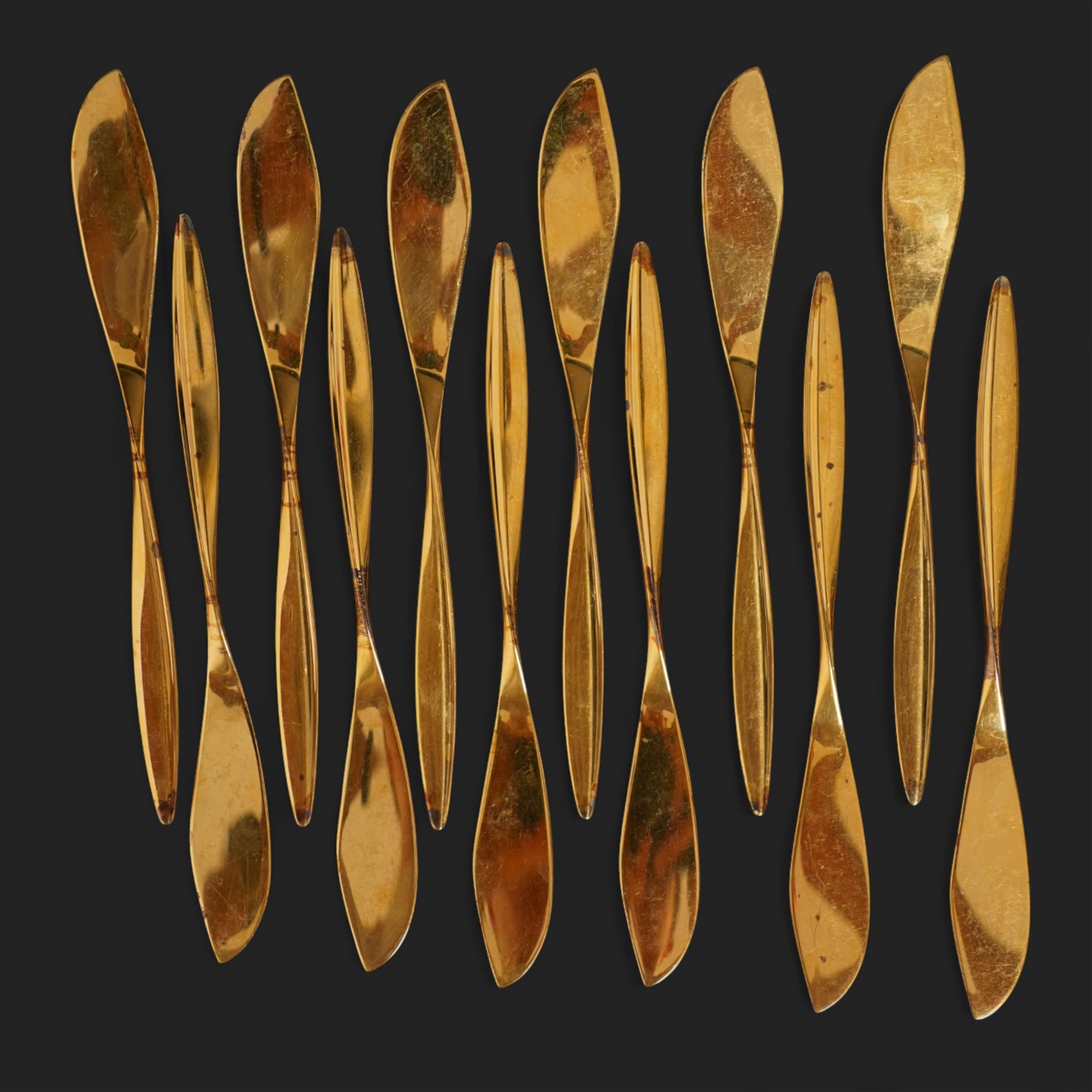Extensive suite of WMF 800 silver gilt cutlery, for twelve covers, comprising twelve table knives and forks, fish knives and forks, dessert forks, table spoons, dessert spoons, teaspoons, eleven dessert forks and six serving spoons, with crescent moon and crown WMF hallmarks