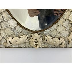 Pair 19th century French Dieppe bone and ivory wall mirrors, the oval bevelled mirror plates within rectangular frames with shaped tops, profusely decorated with ivory leaves, further detailed with carved bone armorial type crest inscribed 'SGOTORVM', putti, fish and mask heads, H81cm W48cm