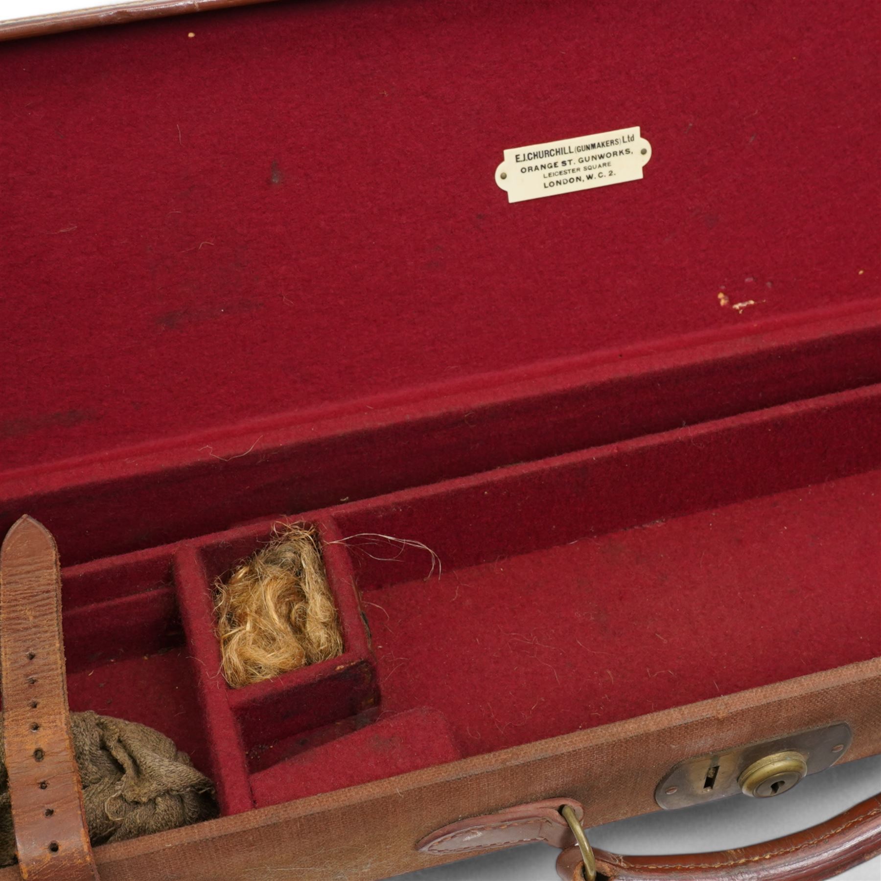 Churchill canvas shot gun case with leather corners and baize lined interior with trade label 'E J Churchill (Gunmakers ) Ltd ' with cleaning rods  and a leather 12 gauge cartridge belt