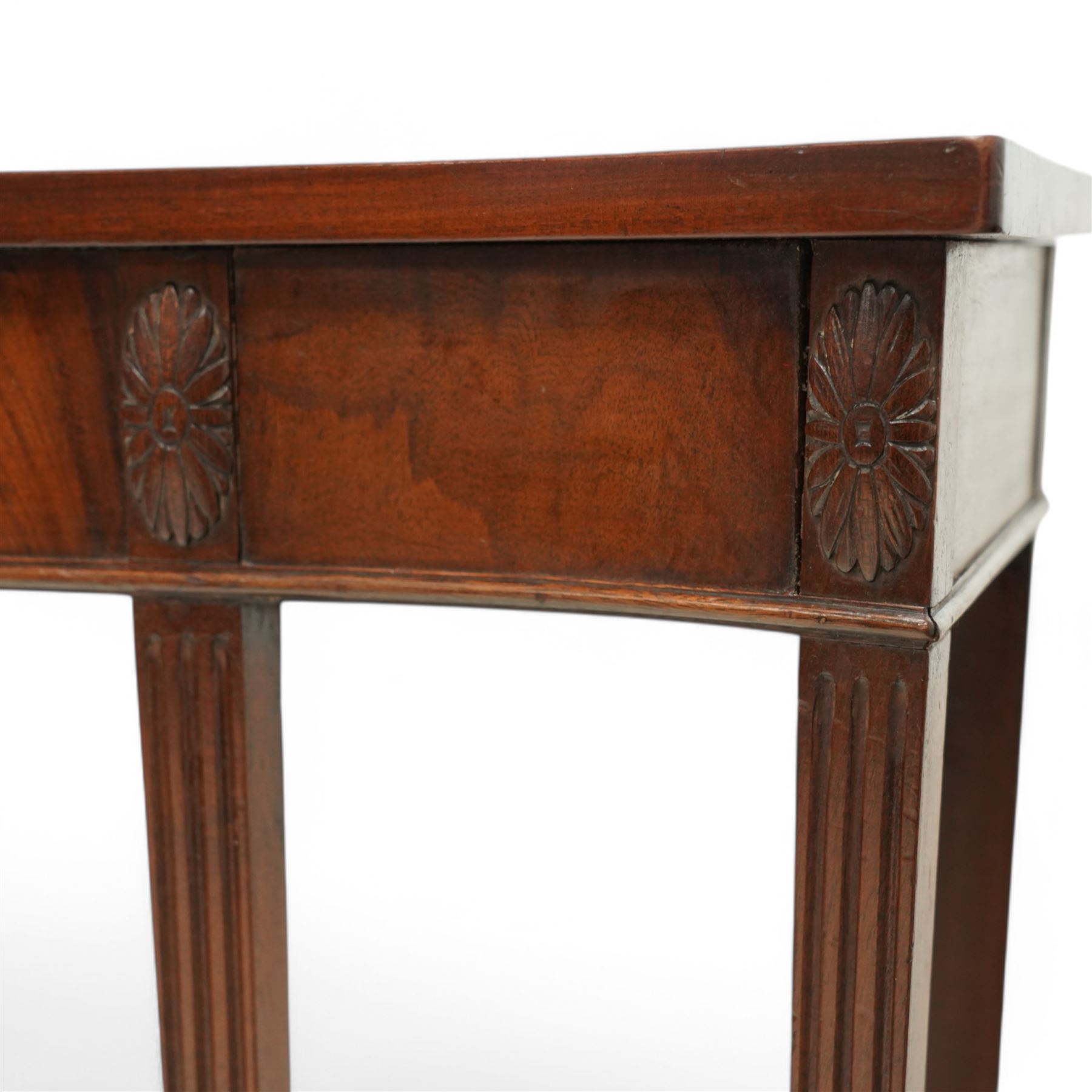 Edwardian mahogany serpentine side table or console table, figured frieze decorated with applied carvings, on six square tapering supports with spade feet