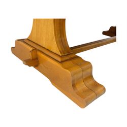 Oak extending dining table with elegant scrolled shaped double pedestal base and scrolled feet; together with a set of eight ladder back chairs with rush seats ((9) table closed 228x95x79cm chairs 106x38x44cm 