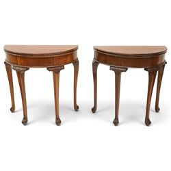 Pair of Victorian mahogany demi-lune card tables, the lunette shaped fold-over top enclosi...
