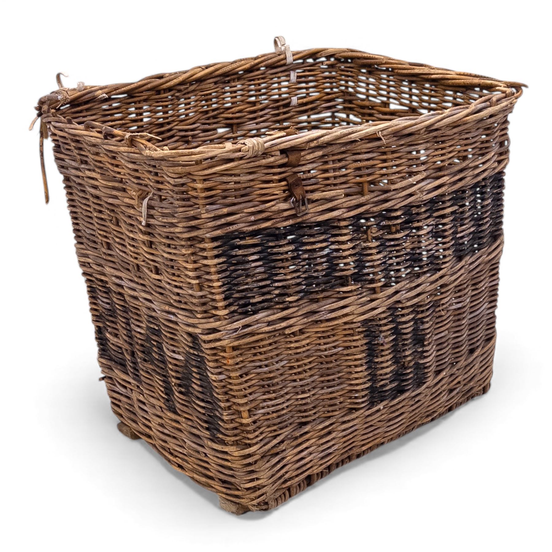 Large 20th century wicker laundry basket, of rectangular form, with stencilled lettering to one sides, raised on wooden base skids