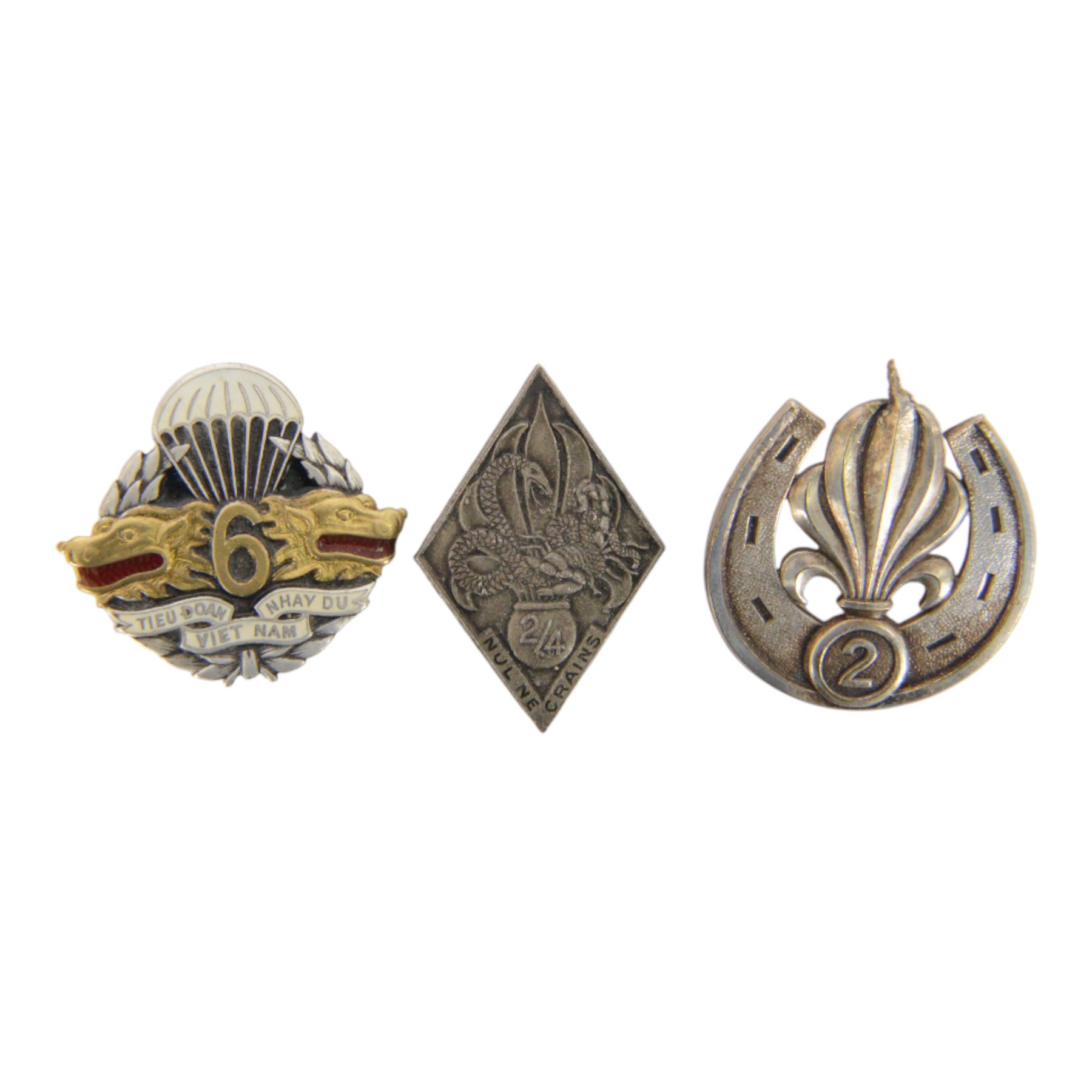 French Foreign Legion etrangere badges comprising seven  Kepi Blance Replacements and two Legion Cavalerie badges
