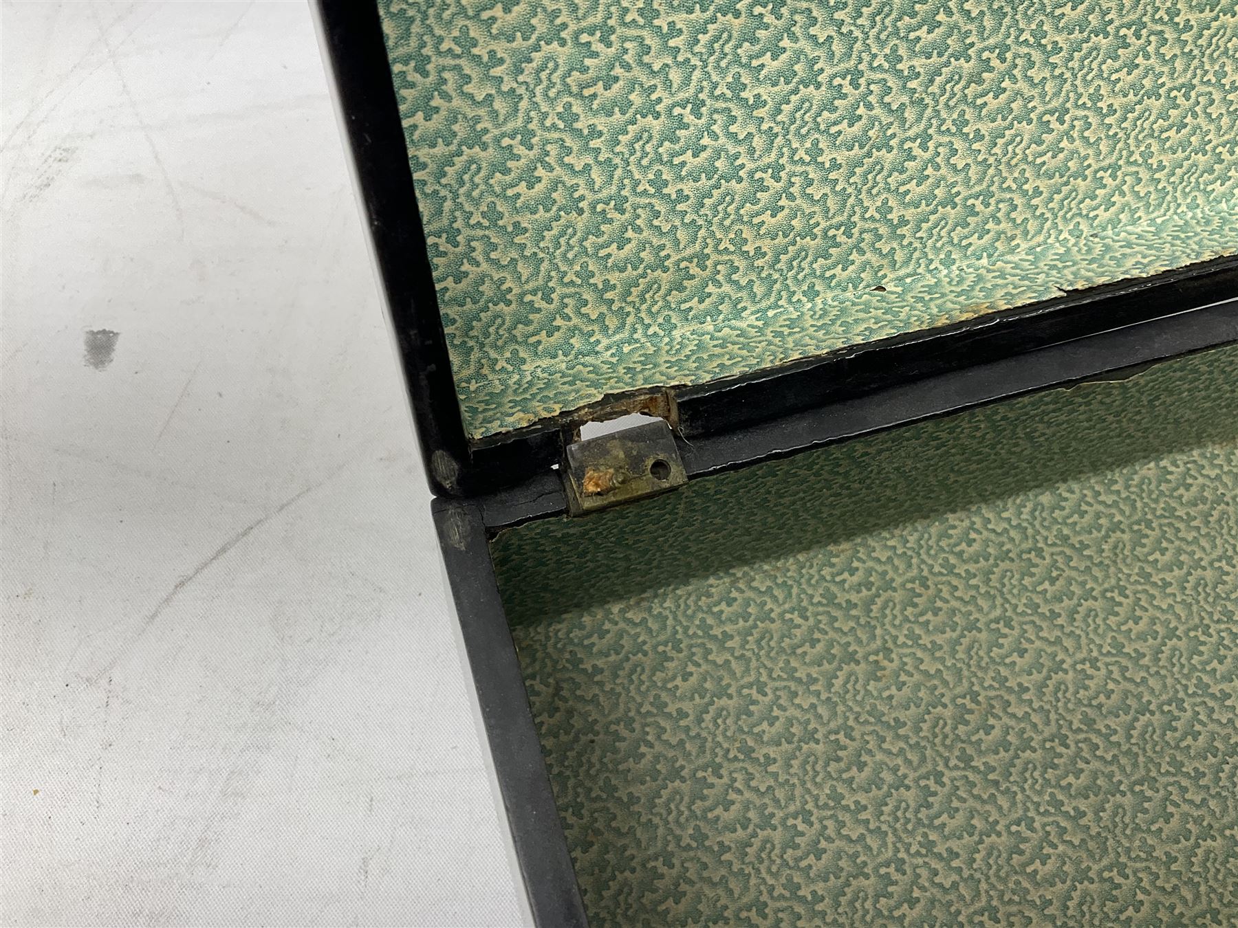  Late 19th / early 20th century Japanese lacquered table top cabinet, heavily decorated with mother of pearl inlay depicting blossoming branches, flowers and birds, the two hinged doors between longer drawers opening to reveal interior fitted with four short drawers, with lift up hinged canted lid, H28cm D9.5cm W23cm, together with mother of pearl inlaid miniature folding screen, dish decorated with walking figures with crimped edge, boxes decorated with flowers, birds and gilt etc