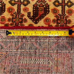 North West Persian Malayer hand-knotted rug, ivory field with central stepped lozenge medallion with angular pendants, surrounded by rows of stylized boteh and geometric floral devices within multiple geometric and stylized vine borders, with fringe ends